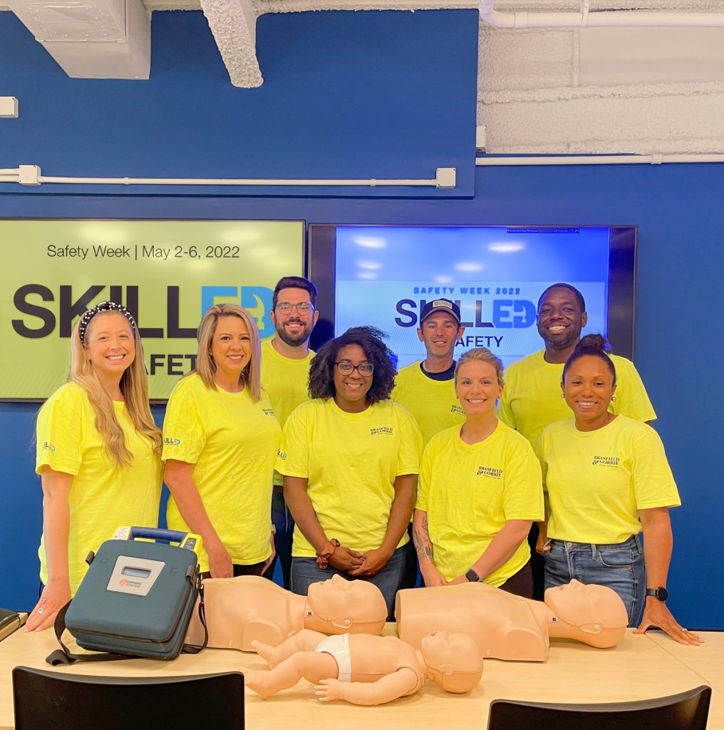 Group photo with CPR dummies for safety training in our Dallas office