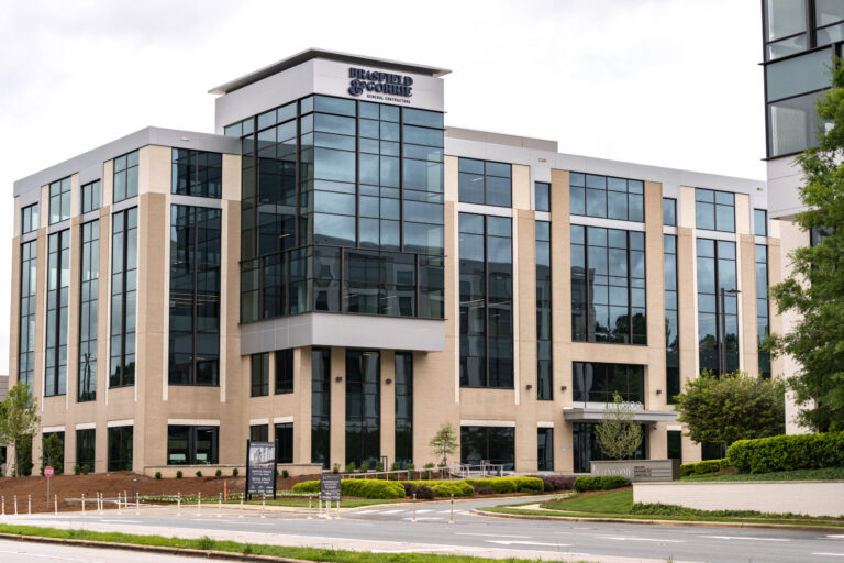 Modern office building with large glass windows and the signage