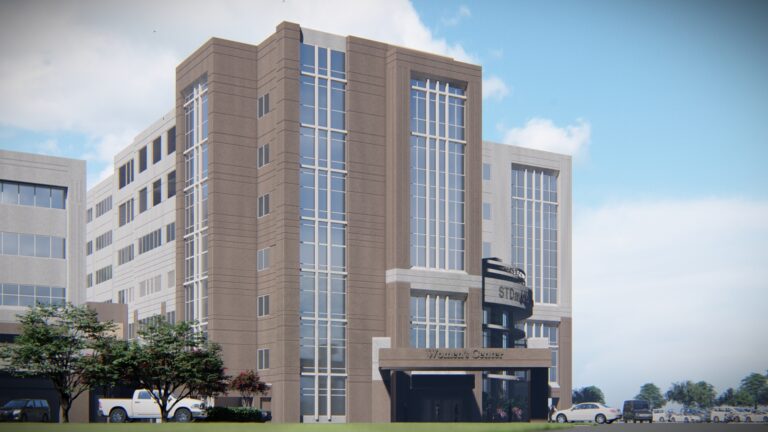 Modern multi-story Brasfield & Gorrie hospital building under a clear sky.