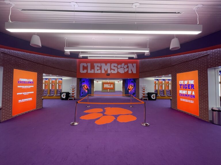 Interior of a renovated Clemson University stadium with school branding and Clemson Tigers-themed decor.