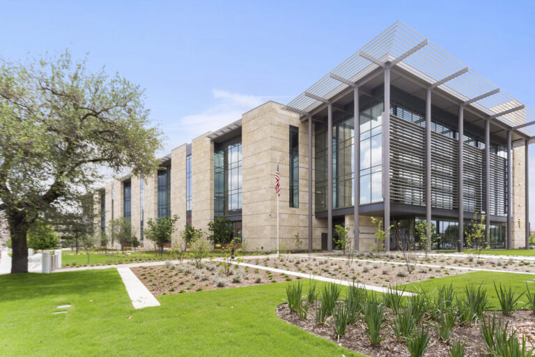 Modern building with vertical louvers and landscaped garden on a clear day, winner of the DBIA National Merit Award.