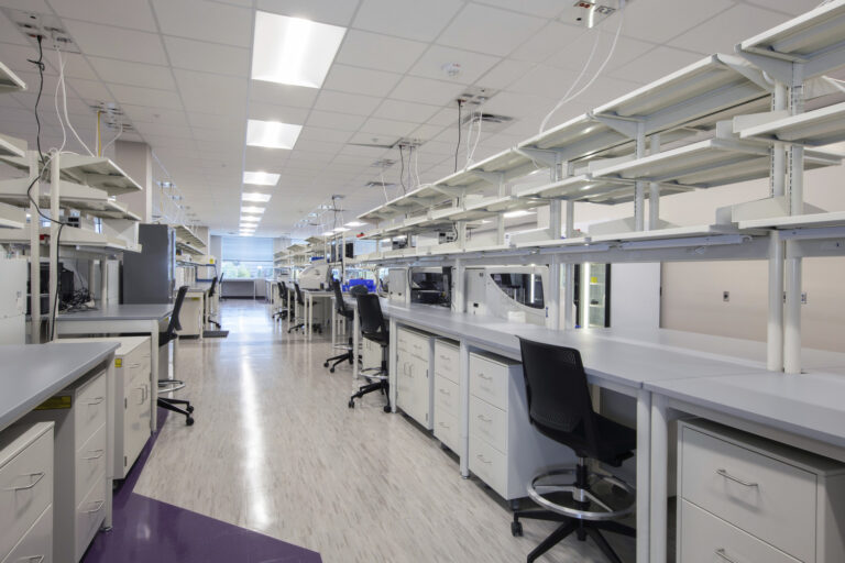 Modern laboratory in North Alabama with workstations, equipment, and cabinets under bright lighting.