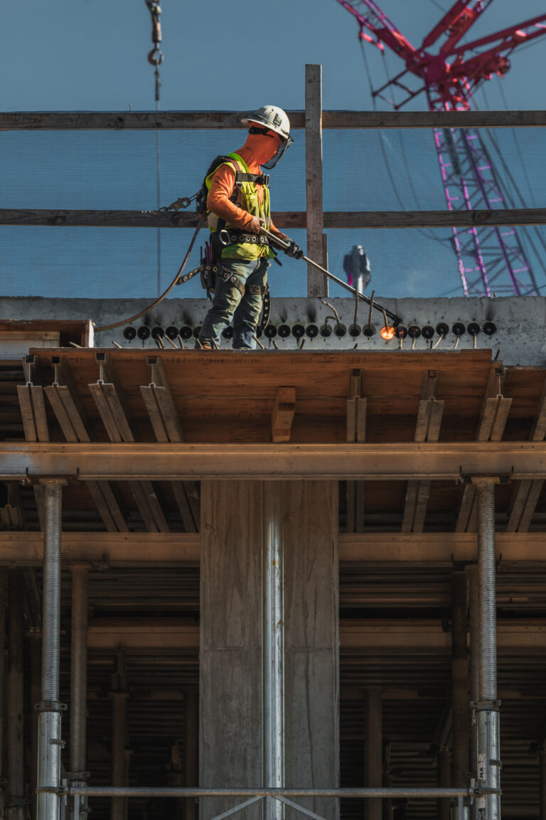A construction worker is working on rebar at a construction site.