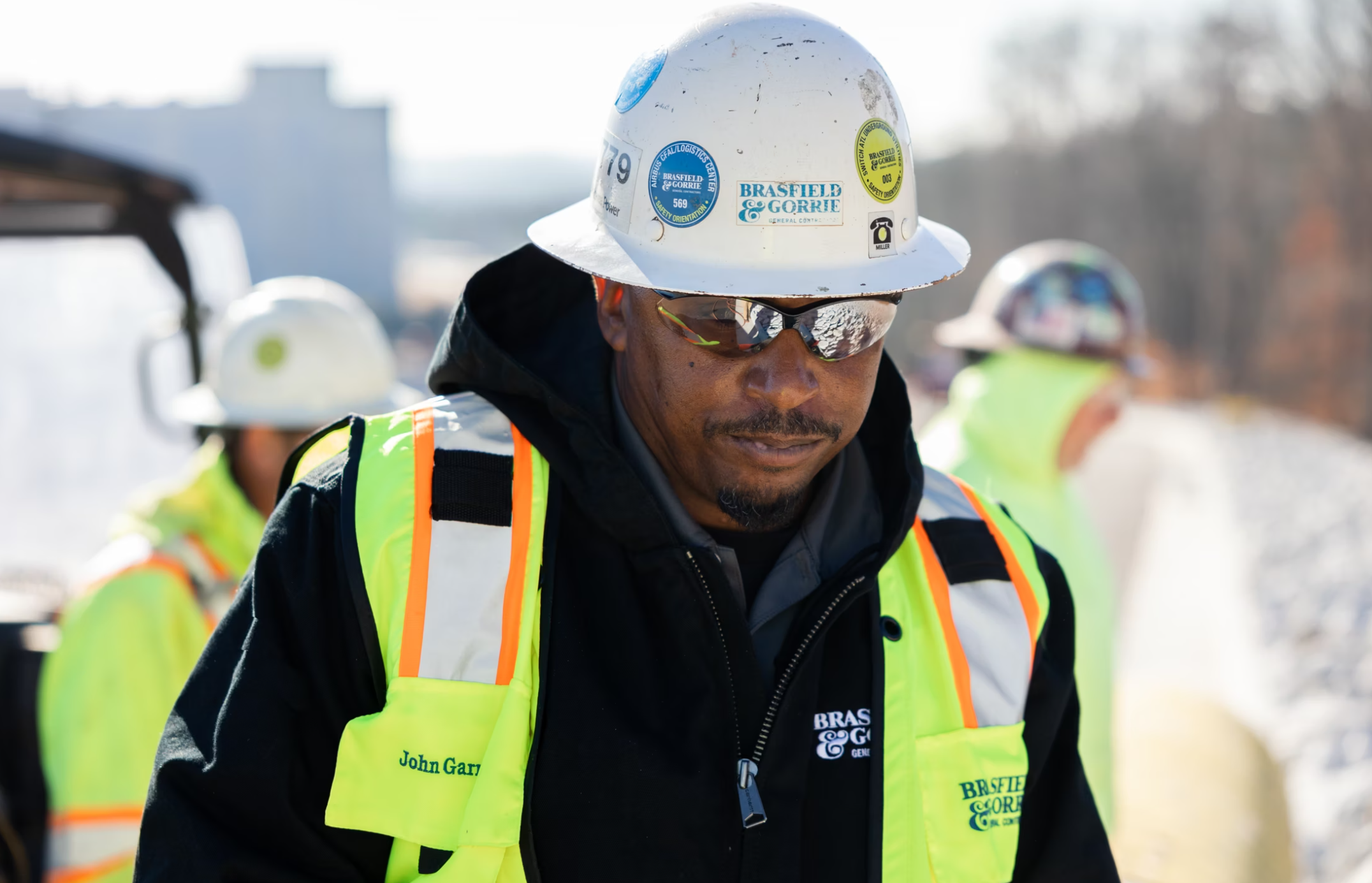 Construction worker in safety gear at a work site, focusing on career development.