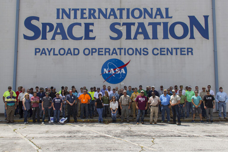 Group of people gathered outside the international space station payload operations center.