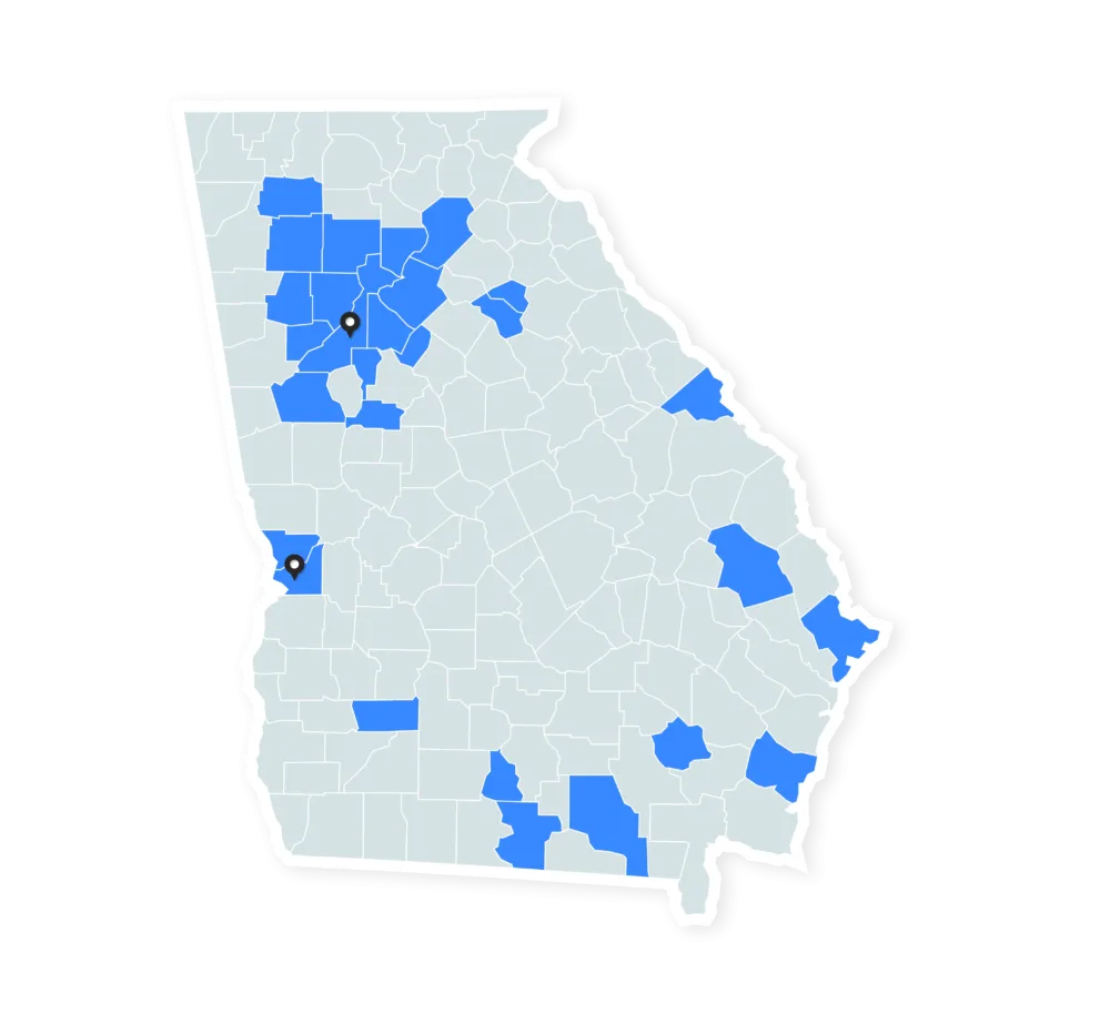 A map of Georgia highlighting select counties in blue, indicating areas where Brasfield & Gorrie has built, with two black location markers placed in Atlanta and Columbus, illustrating B&G offices in Georgia
