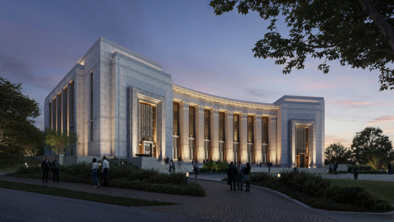 A large, illuminated neoclassical building—possibly the Chattanooga courthouse—displays a grand design concept with tall columns, as people gather outside at dusk, reflecting the work of the General Services Administration.
