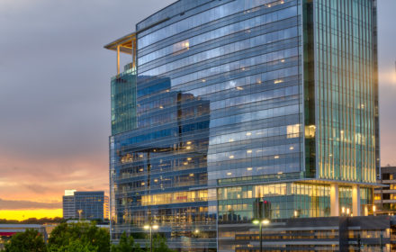 The exterior of Twelve24, an Atlanta office building with floor-to-ceiling windows, shown at sunset