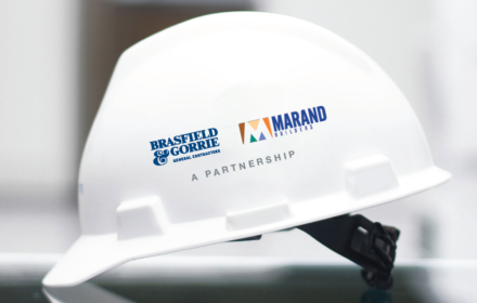 A hard hat featuring the logos of Brasfield & Gorrie and Marand Builders