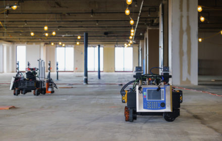 A robotic rover draws layout in an indoor construction site