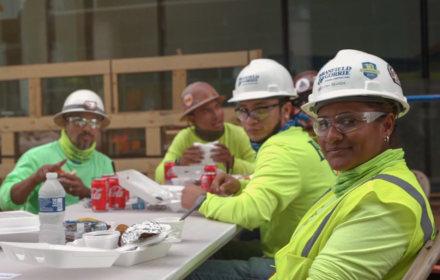 Construction workers sit around a table