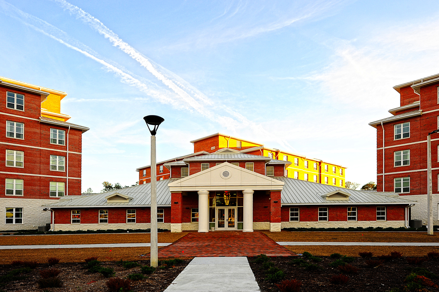 207,000 sq ft design-build Bachelor Enlisted Quarters (BEQ) complex consisting of three, five-story buildings connected by a central multi-purpose common space. Each wing contains 134 high quality double occupancy living modules to house 804 Marines. The project also includes a 650-vehicle multistory parking garage; ancillary structures such as recreational and drying shelters, equipment cleaning areas, athletic courts, and landscaped courtyards; andÂ site work improvements,Â including clearing, driveways, sidewalks, security fencing and gates, turf, potable water, sanitary sewer, natural gas, electric power, and telecommunications. LEED Gold certified.