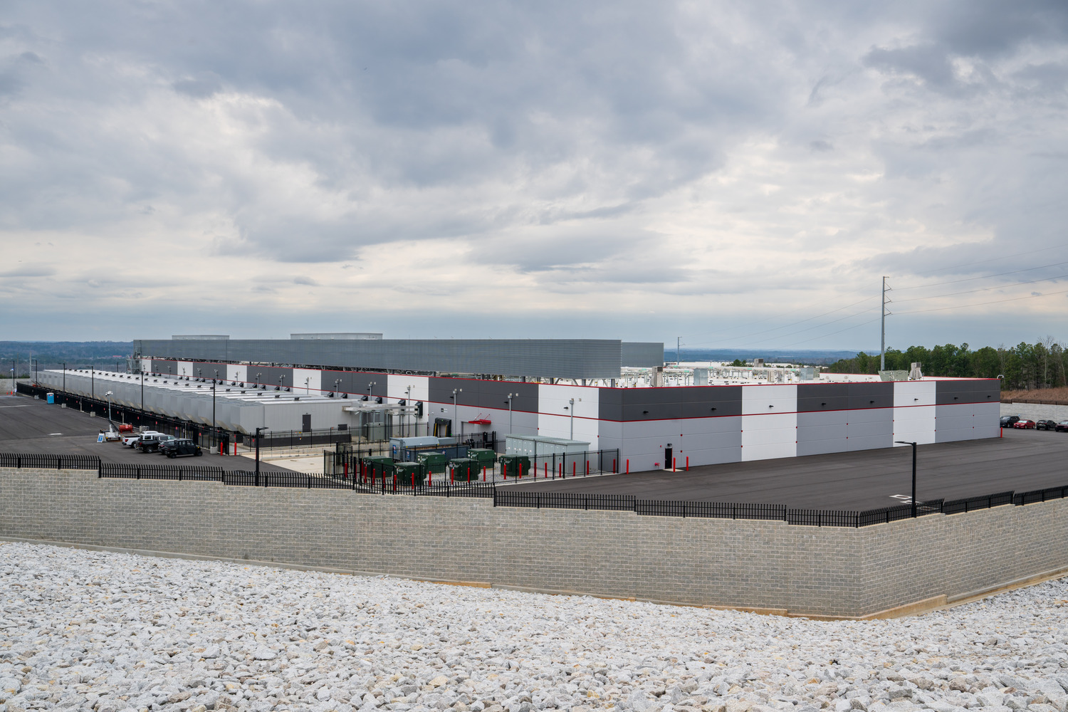 On the roof: Screen Wall - it’s suppose to help that if the GENs are on, producing exhaust, as it rises, the chillers don’t suck it up + suppressing noise from chillers running. 